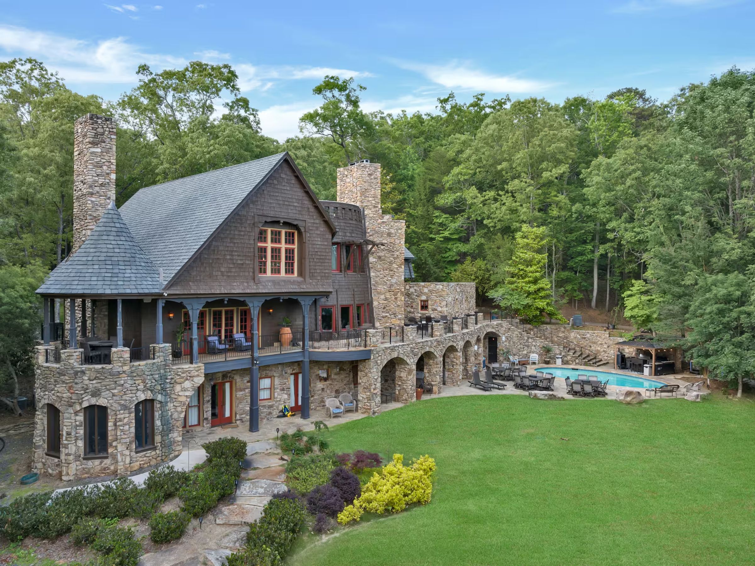 Bellissimo Castle from the lawn, with the pool and Lake Lanier beyond